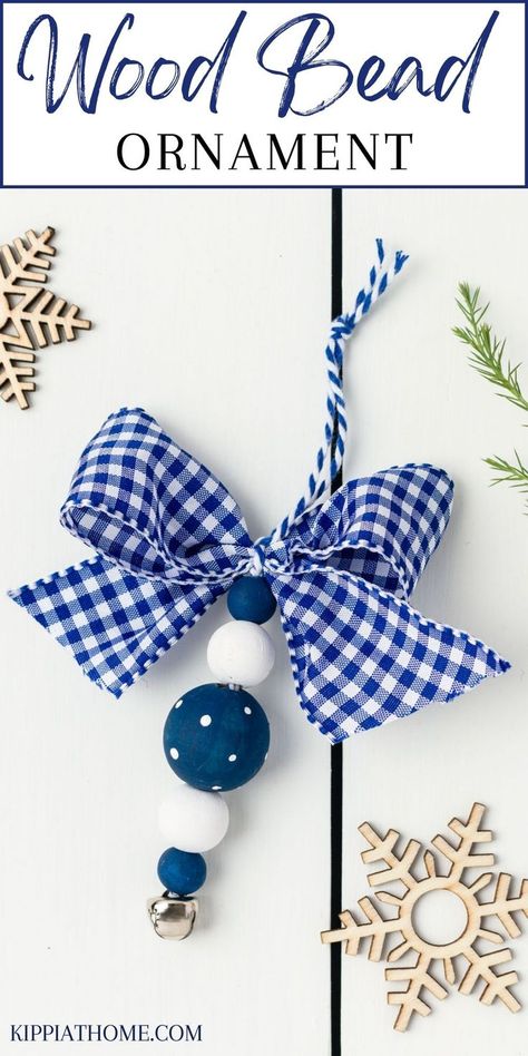 Blue and white wood bead ornaments on a white table Wood Bead Wreath Ornament Diy, Christmas Ornaments Made With Wooden Beads, Easy Beaded Christmas Ornaments, Wooden Bead Star Ornament, Wood Bead Christmas Ornaments Diy, Crafting With Beads, Wooden Bead Projects, Beaded Christmas Decorations Diy, Wood Bead Crafts Diy