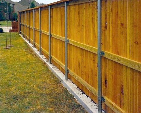 Steel supports in concrete support a wooden fence lining a playground Deck Cleaner, Wood Fencing, Rustic Fence, Cleaning Mold, Termite Control, Fencing Companies, Outdoor Swing, Wooden Fence, Pergola Designs