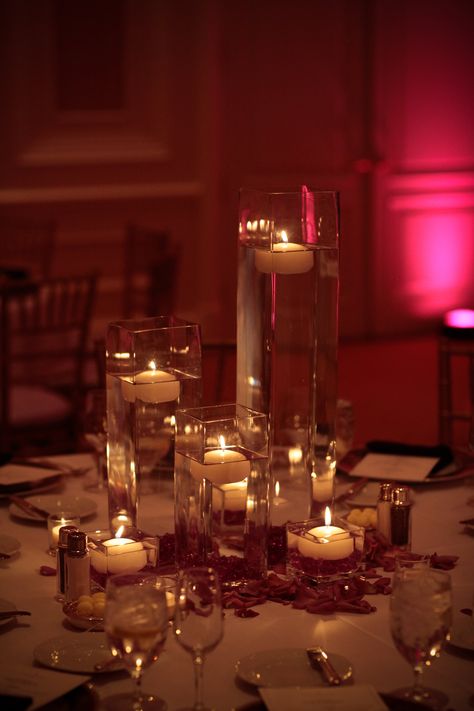 Romantic, simple centerpiece with candles and rose petals Candle And Rose Petal Centerpieces, Vases With Floating Candles, Candles And Rose Petals, Floating Petals, Centerpieces Vases, Floating Centerpieces, Floating Candle Centerpieces, Casino Decorations, 50th Bday