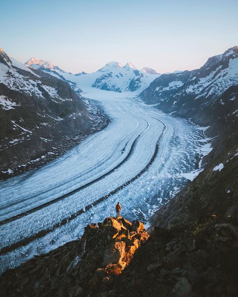 Aletsch glacier at sunrise with a man standing in front of it Trip To Switzerland, Places In Switzerland, Mountain Vibes, Social Media Advice, Backcountry Camping, Travel And Adventure, Hiking Destinations, Switzerland Travel, Hiking Tips