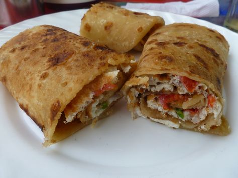 Ugandan street food- called a Rolex It's a omelette wrapped in chapatti or tortilla with tomatoes, eggs and lettuce Uganda Food, Uganda Recipe, Ugandan Culture, Ugandan Food, Tomatoes Eggs, African Kitchen, Chapati Recipes, African Dishes, West African Food