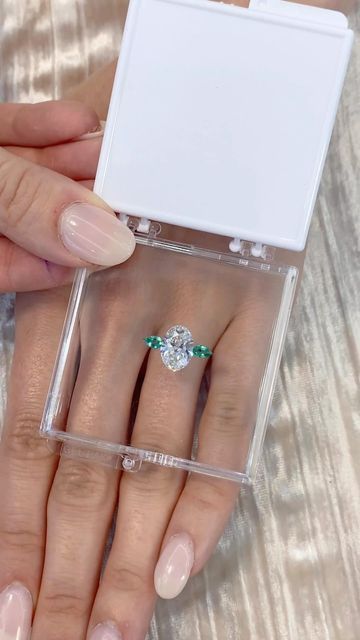 Lauren B on Instagram: "Watch this breathtaking three-stone ring pop to life! 💎 Gorgeous oval diamond featuring green emerald pear shaped side stones - would you say “I DO” to this stunner? 😍🤩 Based on 💍 ring style RS-329 #laurenb #laurenbjewelry #ovaldiamond #ovalring #ringinspo" Ring With Emerald, Three Stone Diamond Rings Engagement, Ring Pop, Future Engagement Rings, Oval Diamond Engagement Ring, Wedding Rings Solitaire, Pear Engagement Ring, Dream Engagement Rings, Alternative Engagement Rings