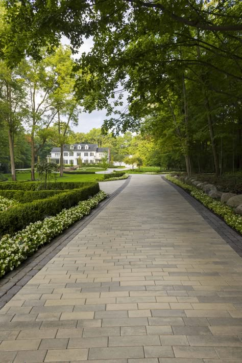 This driveway design idea is inspired by our Linea paver. This paving stone is available in three lengths and two widths for design dimensions that better suit you. Impress the guests with your landscaping by installing a single width to achieve a clean, crisp, linear look, or combine both for a stylish pattern. Check out our website to shop the look! Or, check out the estimation tool on our website to see how much a similar project could cost you! Driveway Design Entrance, Paved Driveway Ideas, Luxury Driveway, Curb Stone, Driveway Entrance Landscaping, Entrance Landscaping, Paved Driveway, Driveway Pavers, Pavers Design