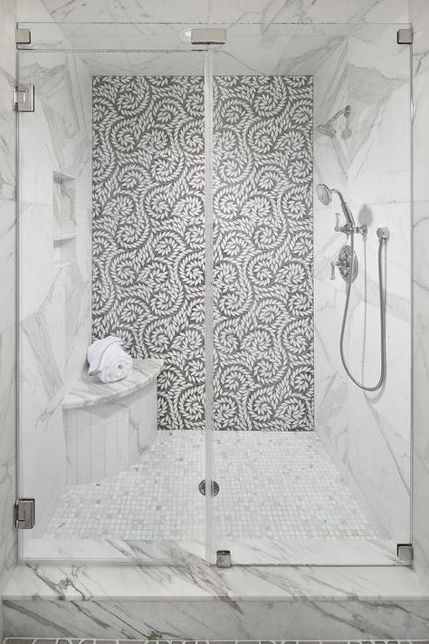 A seamless glass walk-in shower boasts a curved marble shower bench fixed on marble grid floor tiles beneath a tiled niche framed by a marble surround. Corner Shower Seat, Tile Accent Wall, Small Shower Remodel, Marble Showers, Master Shower, Shower Seat, Shower Bench, Shower Niche, Bathroom Shower Tile