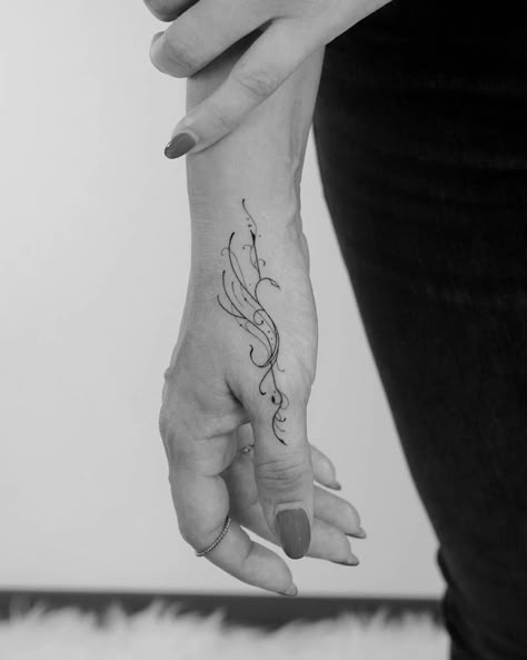 Fine line phoenix tattoo on the hand. Phoenix Tattoo Design Fine Line, Mini Phoenix Tattoo, Phoenix Finger Tattoo, Tiny Phoenix Tattoos For Women, Elegant Hand Tattoos For Women Classy, Phoenix Hand Tattoos For Women, Phoenix Tattoo On Hand, One Line Phoenix Tattoo, Phoenix Tattoo Line Art