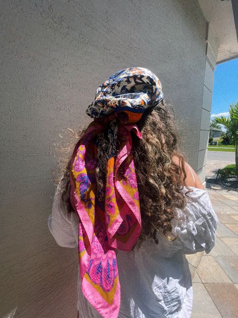 Back of brunettes curly hair with a paisley pink and blue multicolor silk scarf wrapped on top in a tropical climate Hair With Silk Scarf, Scarf For Curly Hair, Curly Beach Hair, Silk Scarf Tying, Silk Scarf Hair, Scarf Tie, Scarf Tying, Beach Hair, Scarf Hairstyles