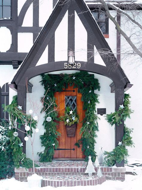 These winter decor ideas for front doors and porches feature natural elements and festive accents. Try one of these DIY projects and styling ideas to create winter door decorations that suit your design style. #christmasporch #frontdoordecor #christmasfrontporchdecoration #porchdecorideas #bhg Tudor House Exterior, Tudor Homes, Exterior Color Palette, Tudor Cottage, Winter Door Decorations, Brick Chimney, Tudor Style Homes, Winter Door, English Tudor