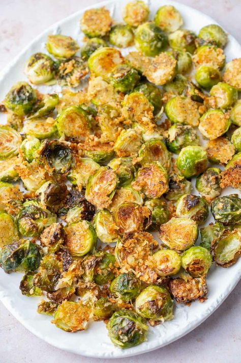 These parmesan roasted Brussels sprouts make a delicious side dish. They are crispy and flavorful - you will be snacking on them straight from the baking sheet! Parmesan Brussel Sprout Recipes, Parmesan Roasted Brussels Sprouts, Brussel Sprout Recipes, Baked Brussel Sprouts, Easy Vegetable Side Dishes, Vegetable Side Dishes Recipes, Roasted Brussels Sprouts, Sprout Recipes, Brussels Sprouts Recipe