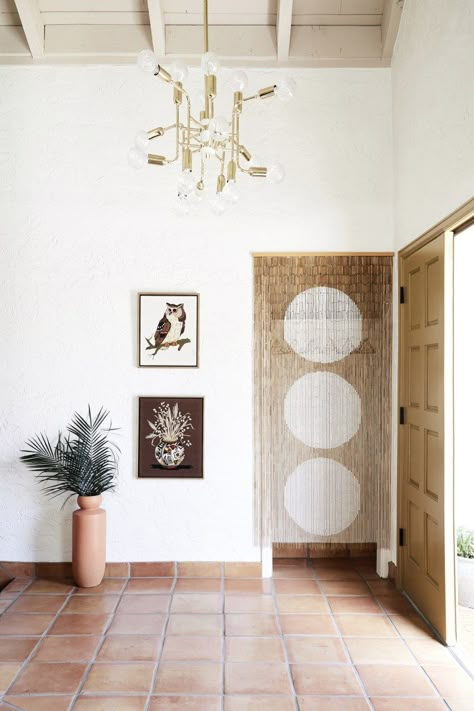 natural terracotta floor welcomes guests in this 70's airy scottsdale home. for natural terracotta options, check out our antique terracotta tiles at cletile.com #entryway #floor #tiles #terracotta Exit Room, Front Hall Closet, Urban Outfitters Curtains, Vintage Coat Hooks, Grey Backsplash, Bamboo Curtains, Terracotta Floor, Fireplace Hearth, Desert Homes