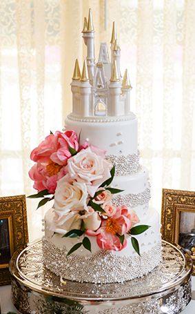 Happily ever after inspired white wedding cake with fresh blooms and a Cinderella Castle cake topper Cinderella Castle Cake Topper, Cinderella Castle Cake, Castle Cake Topper, Disney Wedding Cake, Disney World Wedding, Disney Inspired Wedding, Disney Wedding Theme, Castle Cake, Disney Fairy Tale Weddings