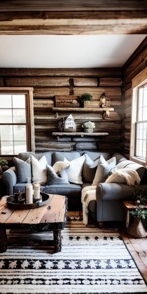 Imagine stepping into a living room that feels like a page out of a woodland fairytale. The log walls, rich in history and character, encase a space that is both cozy and inviting. A grey sofa, adorned with plush pillows, offers a soft counterpoint to the ruggedness, while the raw wood coffee table stands as a testament to rustic artistry. The patterned rug underfoot adds a touch of modern design sensibility, grounding the space in comfort. Cabin Artwork Ideas, Cabin Home Decor Living Room, Farmhouse Log Cabin Interior, Cabin Couch Ideas, Lodge Cabin Living Room, Small Log Cabin Homes Interior Decor, Cozy Log Cabin Living Room, Mountain Cabin Decor Lodge Style Bedrooms, Rustic Outdoorsy Home Decor