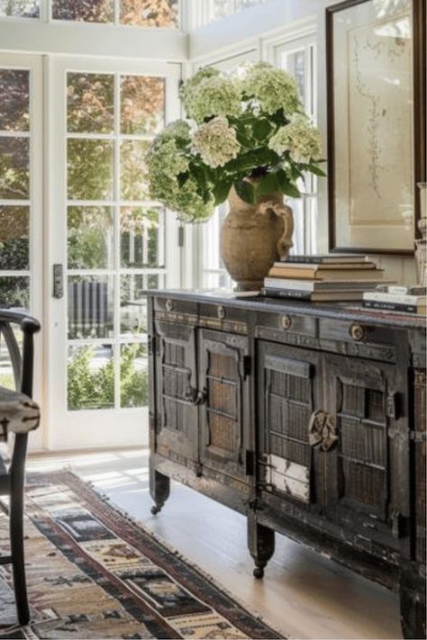 Invest in a statement antique credenza, to anchor your dining room. Whether it’s a rustic farmhouse table or a sleek modern design, a standout table can set the tone for the entire room. Pair it with unique chairs for an eclectic look that reflects your personal style. Your dining room will become a stylish space perfect for family meals and entertaining guests. Light up your dining room with a chandelier or unique light fixture. The right lighting can create a warm, inviting atmosphere for ... Antique Credenza, Southern Traditional Home, French Country Family Room, Credenza Styling, Dining Room Credenza, French Farmhouse Table, Unique Chairs, French Country Chandelier, Dining Room French