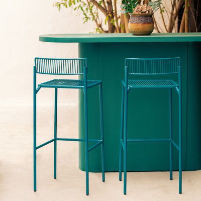 Clean and refined the Rachel stool is modern simplicity. The Rachel Patio Stool is a wire stool designed for everyday use. Its metal frame and powder coat finish make it a durable yet lightweight option that's great for outdoor dining. Her slim stature makes this an easy choice for a bar setting so you can fit multiple stools nicely. Bend Goods Frame Color: Peacock Blue, Seat to Floor Height: 26" Bend Goods Rachel Counter Stool - Bar Stools in Peacock Blue | Size 26" | Perigold Outdoor Bar Chairs, Wire Bar Stools, Colorful Bar Stools, Bar Setting, Color Peacock, Patio Bar Stools, Designer Bar Stools, Bar Patio, The Rachel