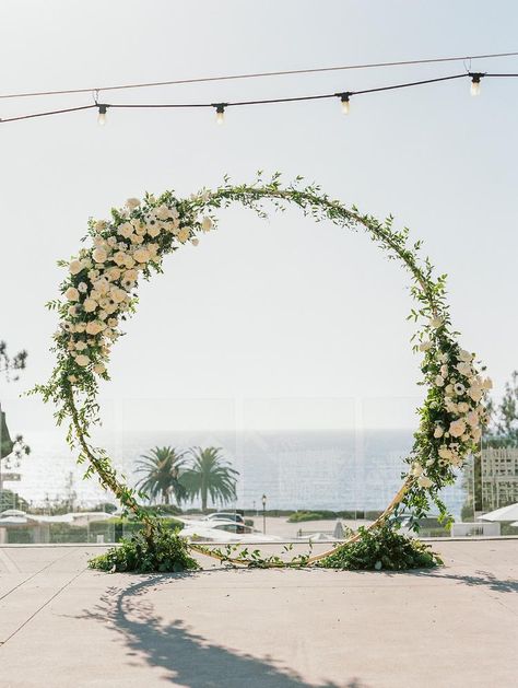 An Elegant Seaside Wedding With A Family Heirloom You'll Just Have to Read About! Oval Wedding Arch Ideas, Wedding Arch Circular, Floral Arch Wedding Outdoor, Floral Wedding Circle Arch, Round Beach Wedding Arch, Circle Wedding Arch White Flowers, Gold Circular Wedding Arch, Beach Wedding Arch, Metal Wedding Arch