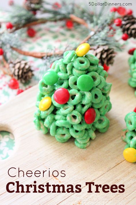 Here's a fun twist on Rice Krispie treats...Cheerio Christmas Trees! These trees are perfect for a fun food-craft this holiday season. The fact that they're super simple to make is just the icing on the cake. | #ChristmasTreats #ChristmasSnacks #ChristmasCookies Christmas Cheerios Recipes, Rice Krispie Christmas Treats, Rice Krispy Treat Recipe, Christmas Tree Treats, Holiday Rice, Cheerios Recipes, Christmas Tree Food, Holiday Snack, School Christmas Party