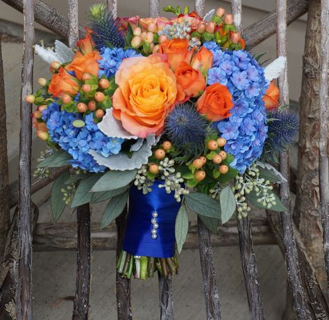 I had so much fun designing this blue, orange and peach bouquet! Flowers are hydrangeas, Free Spirit Roses, peach hypericum berries, Spray Roses and lush seeded Eucalyptus (flowerartistry.ca) Feb Wedding Flowers, Light Blue And Orange Wedding Bouquet, Cornflower Blue And Orange Wedding, Orange And Blue Centerpieces, Prom Bouquet Ideas Color Schemes, Blue And Orange Bouquet, Orange And Blue Bouquet, Peach Hypericum, Blue And Orange Wedding