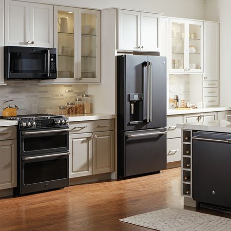 These on-trend appliance finishes help express your style, shake up the look of your kitchen and make an update feel fresh. Stove Next To Refrigerator Kitchen, Kitchen Colors Schemes With Black Appliances, Black Frigerator In Kitchen, Black Fridge Kitchen Interior Design, Small Kitchen Ideas Black Appliances, Stainless Black Kitchen Appliances, Cabinet Color With Black Appliances, Kitchenaid Black Stainless Appliances, Black Appliances With White Cabinets