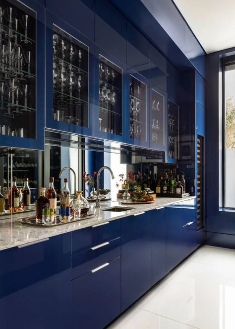 This oversized bar leaves quite the impression. Featuring a custom, high gloss, floor-to-ceiling blue lacquer with integrated refrigerator drawers, an ice maker, and a wine cooler.⁠ ⁠ High Gloss Blue Kitchen Cabinets, Modern Home Bar Designs, Dojo Design, High Gloss Kitchen Cabinets, Gloss Kitchen Cabinets, Integrated Refrigerator, High Gloss Kitchen, South American Art, Modern Home Bar