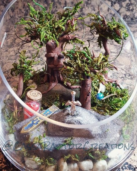 Legend of Zelda Terrarium #RaptorCass #legendofzelda #mastersword #zelda #link #terrarium #ocarinaoftime #hearts #jarofhearts #miniatures #sculpey #sculpting #breathofthewild #navi #listen Zelda Centerpiece, Pokemon Wedding Centerpieces, Video Game Centerpieces, Nerdy Centerpieces, Nerdy Terrarium Ideas, Legend Of Zelda Room Ideas, Legend Of Zelda Wedding Centerpieces, Hobbit Terrarium, Nerdy Terrarium