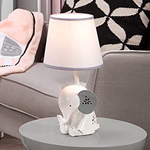 Style Modern Brand Lambs & Ivy Color White Product Dimensions 7"D x 7"W x 14.25"H Light Source Type Incandescent Polyresin Custom designed white resin elephant lamp with gray ears and floral details Soft white lamp shade with gray trim adds the perfect finishing touch This “grow with me” lamp can be enjoyed by your little one for years to come Adds a designer touch to your baby or child's room Includes an energy-efficient light bulb which uses less energy than a standard incandescent bulb Grey Elephant Nursery, Mini Crib Bedding, Elephant Lamp, Wall Decor Storage, Lambs & Ivy, Lamp With Shade, Toddler Bed Set, Nursery Lamp, Flower Shapes