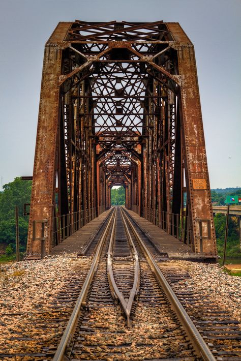 This old four span through truss bridge spans over Red River on a railroad line. It runs just east of U.S. 69/75 highway and crossing the Texas & Oklahoma border.  You can find out more about the bridge by visiting BridgeHunter.com  I wish the sky had been a little more interesting, but had been raining all day which did give the rocks and bridge some much needed color and texture. Moore Oklahoma, Train Bridge, Old Bridges, Truss Bridge, Railroad Bridge, Abandoned Train, Light Speed, Railway Bridges, Old Trains