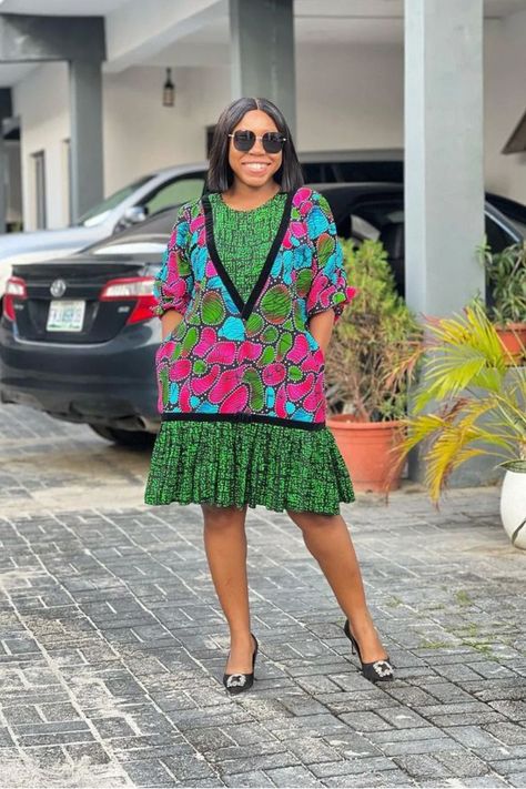 A lady wearing a mix of Ankara print 2 Yards Ankara Short Gown Styles, Ankara A Line Gown Styles, Simple Ankara Gown Styles, Ankara Gown Styles For Ladies, Simple Ankara Gowns, Gown Styles For Ladies, Latest Ankara Short Gown, Short Gown Styles, Casual Gowns