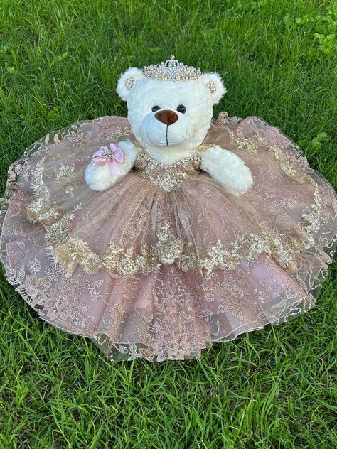 Ideal bear for your quinceanera party, it measures approximately 17" Each dress of our bears is custom designed matching the tone to the color of your quinceanera dress. It is worth mentioning that the tone of the fabric may vary, as well as the accessories (crown, earrings or necklace) If you need a more personalized bear or the same as your dress, it can also be made. Our specialty is satisfying our clients. You can contact us if you require a custom design. Contact: 817-443-7252 FB: Norma Vazquez Fashion Designer https://www.facebook.com/profile.php?id=100077462744454 Quince Bear Pink, 15 Dresses Quinceanera Pink, Big Quinceanera Dresses, Dresses Quinceanera Pink, Quinceanera Ideas Pink, Quince Doll, Quinceanera Teddy Bear, Rose Gold Quince, Hispanic Jokes