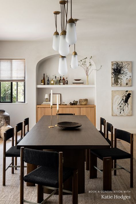 This dining room designed by Katie Hodges features an Apparatus Studio chandelier, a home bar recessed into an arched nook, and a modern dark wood dining table. Like what you see? Book a 1:1 video consultation with Katie Hodges on The Expert and get personalized interior design advice for your space. Dining Room Built In, Dark Wood Dining Table, Luxe Magazine, Dark Dining Room, Dark Wood Table, Chic Dining Room, Golden Rules, Furniture Office, Dining Room Inspiration