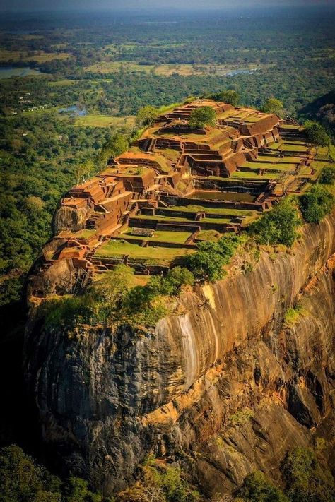 Sigiriya is an ancient rock fortress located in Sri Lanka. It is also known as the "Lion Rock" because of the lion-shaped gateway that once existed at the entrance. Sigiriya is a UNESCO World Heritage Site and is famous for its historical and archaeological significance, as well as its stunning frescoes, gardens, and the remains of a palace at the top of the rock. It's a popular tourist attraction and provides a glimpse into Sri Lanka's rich history. Sigiriya Sri Lanka, Earth Activities, Holiday Trip, Travel Japan, Medical Tourism, Travel Vlog, Natural Scenery, Famous Places, Historical Place