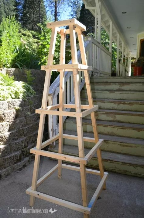 I needed something decorative in my garden and also a support to different plants. I love garden obelisks but the plans I found were rather complicated so we came up with a quick and easy one for about $20 at the time of building, costs may vary depending on your location. A step by step and a rough drawing are available on my website.     We used 2 x 2 pine lumber but you can also use a mix of the 2 x 2's and 1 x 2's for variation.      The side "rungs" are what can be cut from 1 x 2's ma… Obelisk Trellis Diy How To Build, Obelisk Diy, Garden Topiary, Obelisk Trellis, Veggie Gardens, Garden Obelisk, Outdoor Trellis, Diy Trellis, Gardening Diy