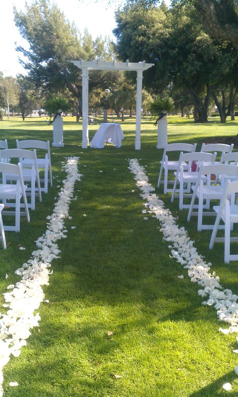 white rose petals down the aisle, awaiting the bride. White Petals Down Isle, Aisle Lined With Petals, Flower Petals Lining Wedding Aisle, Flower Peddles Down The Aisle, Flower Pedals Down Aisle, Walking Down The Aisle Decoration, Rose Petal Wedding Aisle, Rose Petals Down Aisle, Rose Petal Walkway