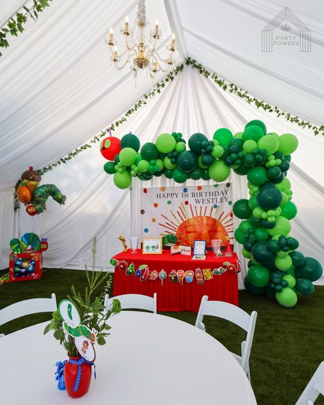 30x30 A Very Hungry Caterpillar Theme 🐛 . Rentals 👇🏽 30x30 Tent with White Draping 2 Gold Chandelies Ivy Vines on the tent 9 round tables with white tablecloth 72 White Padded Chairs 7’x7’ White Pipe and Drape Backdrop with balloons . #tent #draping #white #caterpillar #1st #birthday #party Hungry Caterpillar Backdrop, White Caterpillar, Tent Draping, A Very Hungry Caterpillar, Drape Backdrop, Pipe And Drape Backdrop, White Tablecloth, Ivy Vine, Pipe And Drape