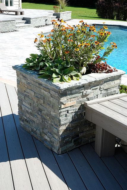 Stacked Stone Planter.  We could make these a little larger/taller to be the parking ballards out front.  We could add the vented down lighting louvers and some electrical access plugs Stacked Stone Planters, Stone Planter Ideas, Island Deck, Rock Planters, Outdoor Yard Ideas, Stone Porches, Dry Stack Stone, Stone Planter, Decking Ideas