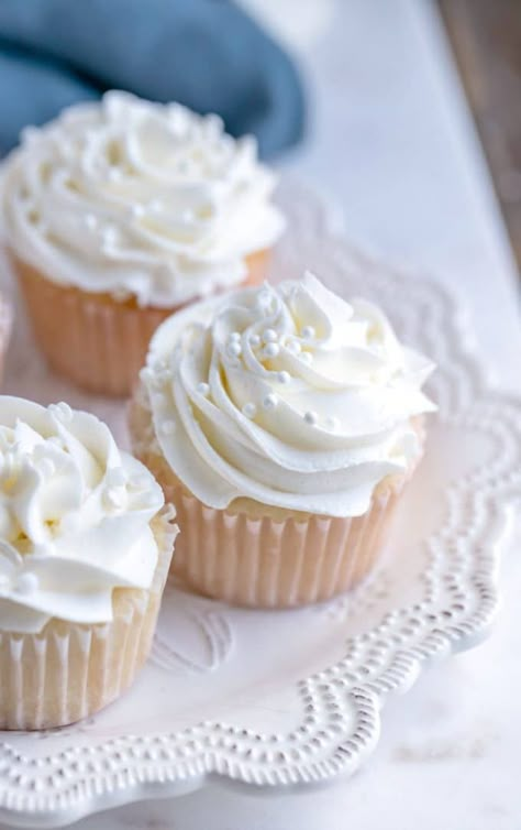 White cupcakes with white frosting on a white plate White Bridal Shower Cupcakes, Pearl Themed Bridal Shower Ideas, White Cupcakes With Pearls, Pearls And Prosecco Birthday Theme, Bridal Shower Cupcake Cake, Pearls And Prosecco Bridal Shower Theme Cookies, Bridal Shower Ideas Pearls, Pearl And Prosecco, Pearls Birthday Theme