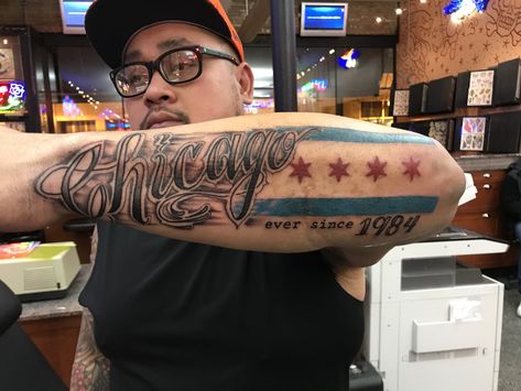 Chicago script with Chicago flag stars and bars forearm tattoo Chicago Forearm Tattoo, Chicago Themed Tattoos, Chicago Arm Sleeve Tattoo, Chicago Tattoo Ideas Men, Chicago Inspired Tattoos, Chicago Skyline Tattoo Men, Chicago Tattoo Ideas, Chicago Tattoo Artist, Chicago Flag Tattoo