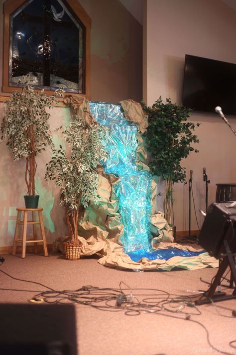 DIY Waterfall Stage Decor - Borrowed BlessingsBorrowed Blessings Waterfall Decoration, Waterfall Ideas, Diy Waterfall, Jungle Decorations, Vbs Themes, Stage Decor, Waterfall Wall, Baby Stage, Vacation Bible School