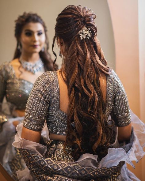 We are all hearts of this gorgeous half-tie hairstyle featuring voluminous curls and a beautiful hair accessory in the centre. #bridalhairstyling #bridalhairaccessories #bridalhairstyle #bridehair #bridalhairandmakeup #bridalhairstyles #bridalhairdo #bridalhair #shaadisaga #bride #bridalinspo #bridalinspiration Reception Hairstyles, Hairstyles For Indian Wedding, Engagement Hairstyles, Bridal Hairdo, Bridal Hair Buns, Indian Wedding Hairstyles, Open Hairstyles, Indian Bridal Hairstyles, Bridal Hairstyles