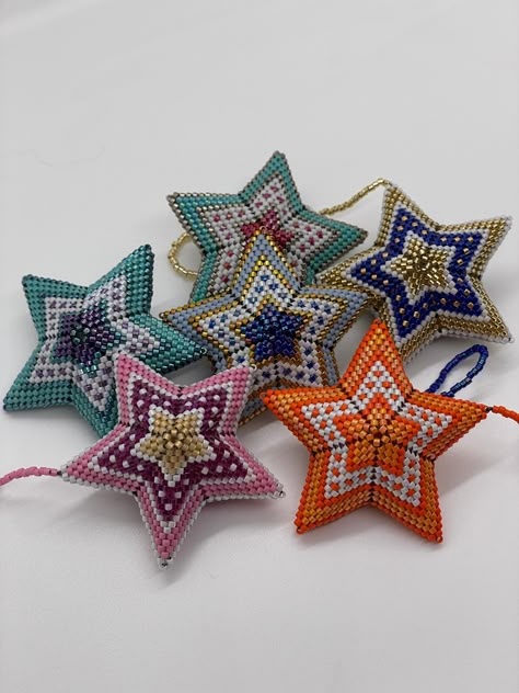 Hand-beaded 3-D star ornaments. These ornaments look great on any Christmas tree, but they can be also hung from your rearview mirror, a pendant, turned into earrings or even hanging from your purse handle.  Available in assorted colors.  Name your color and I'll hand-bead one just for you.  Handmade in the USA! Bead Stars, Beaded Stars, Bead Christmas Ornaments, Beaded Star, Star-shaped Beaded Necklace For Gift, Bead Star Ornaments Diy, Wood Bead Star Ornament, Beaded Star Ornament, Diy Beaded Ornaments