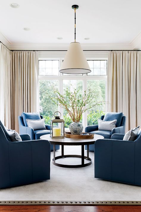 A seating arrangement features four blue-leather swivel chairs against a backdrop of subtly striped draperies; black hardware, a light fixture edged in black and upper windows detailed in graphite paint unite the space.  Interior Design: Kristin Peake Interiors Photo: Stacy Zarin Goldberg  #handdportfolio #top100designers  #kristinpeakeinteriors #design #interiordesign #dmvdesigners #dmvinteriordesigners #dmvinteriors #designinspo #inspiration #details #decor #livingroom 4 Chair Living Room Arrangement, Conversation Room, Living Room Swivel Chairs, Bar Lounge Room, Sitting Room Design, Conversation Area, Sitting Room Ideas, Living Room Arrangements, Living Vintage