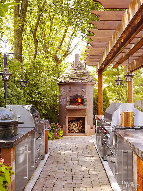 Outdoor Kitchen Plus - A galley-style kitchen equipped with all the bells and whistles lines up along a stone pathway leading to a focal-point wood-burning oven that also serves as a fireplace. Most any recipe can be cooked up using the pizza oven, gas burners, grill, smoker, or rotisserie. Stainless-steel cabinets and stone countertops enhance the kitchen's purpose and good looks. Kawaii Interior, Backyard Pizza Oven, Luxury Outdoor Kitchen, Rustic Outdoor Kitchens, Modern Outdoor Kitchen, Outdoor Kitchen Bars, Outdoor Pizza, Rustic Outdoor, Dream Backyard