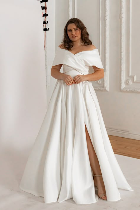 Features: Ready to ship wedding dress.  Color: Light ivory The off-the-shoulder twisted top is designed to wrap around your waist like a bow, giving the entire bodice a royal and sophisticated look. The skirt features subtle pleats at the waistline, creating a feminine and elongated silhouette. ----Shipping conditions:        We ship the dresses within 1-2 days.  ----Made-to-order dresses:       We do not create dresses to order or offer customization. ----Return:      We accept returns. Restock Surplice Wedding Dress, Wedding Dresses Timeless Classy, Bridal Dresses Curvy Bride, Gown For Plus Size Women Wedding, Wrap Around Wedding Dress, Wedding Dress Covered Shoulders, Off Shoulder Wedding Dress Curvy, Classy Off The Shoulder Wedding Dress, Wedding Dresses Plus Size Simple