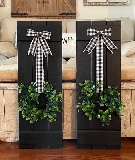 Farmhouse Wood Shutter Wall Decor, complete with charming Buffalo Check Wreath.  Each piece measures 30" x 10.5" and can be purchased separately.  Create a stunning focal point in any room with this rustic and elegant decor set. The farmhouse wood shutters add a touch of vintage charm, while the buffalo check wreaths bring a pop of colour and pattern.  Hanging hardware is included on the back.  Measurements may vary up to one inch. Shutters Inside Decor, Holiday Shutter Ideas, Wood Shutter Craft Ideas, Things To Do With Old Shutters, Using Shutters As Wall Decor, Farmhouse Door Decor, Dollar Tree Picket Fence Crafts, Shutter Christmas Decor, Diy Shutters Indoor Wall Decor