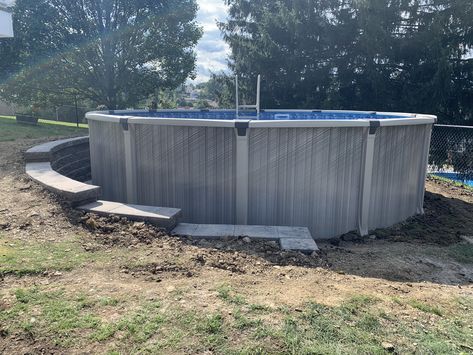 I had a retaining wall build around the half of my above ground pool that was dug into my sloped yard. We used versalock wall blocks for this project. Retaining Wall For Pool Sloped Backyard, Above Ground Pool Ideas Sloped Yard, Retaining Wall Above Ground Pool, Retaining Wall For Pool, Above Ground Pool Half In The Ground, Retaining Walls Around Pools, Above Ground Pool Deck Ideas Sloped Yard, Retaining Wall Around Pool Ideas, Above Ground Pool With Retaining Wall