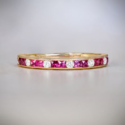 This diamond and ruby half-eternity band features an alternating pattern of round brilliant cut diamonds and French cut rubies, channel-set in gold. The total weight of the rubies is 0.36 carats and the round brilliant cut diamonds weigh 0.15 carats total. This wedding band is handcrafted in 18k yellow gold and decorated with fine milgrain.
The width of this band is 2.5mm.
This band can be resized up or down by one size from its current size, which is 6.5. If a different size is desired, it can Ruby Eternity Ring, Ruby Wedding Band, Estate Diamond Jewelry, Ruby Bands, Wedding Band Styles, Half Eternity Wedding Band, Ruby Wedding, French Cut, Vintage Wedding Band