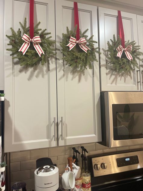 Bows On Cupboards, Christmas Wreath On Cabinet Door, Christmas Wreaths Kitchen Cabinets, Wreath On Kitchen Cabinet, Christmas Wreaths On Cabinets, Kitchen Cabinet Christmas Wreaths, Decorating Kitchen For Christmas, Wreaths On Cabinets, Wreaths For Kitchen Cabinets