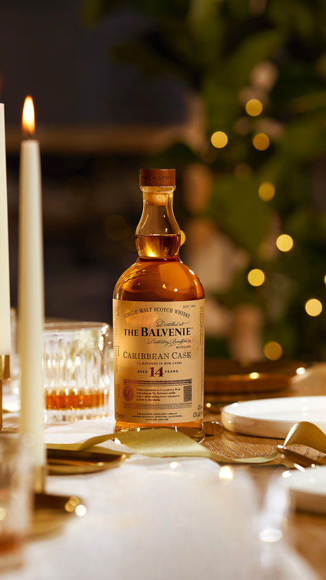 A bottle of The Balvenie Caribbean Cask Aged 14 Years single malt scotch whisky sits on a festive table decorated for a holiday meal New Years Gift Ideas For Friends, Christmas Alcohol Photography, The Balvenie, Rum Photography, Whiskey Photography, Meat Photography, Whisky Collection, Dont Drink And Drive, Holiday Photography