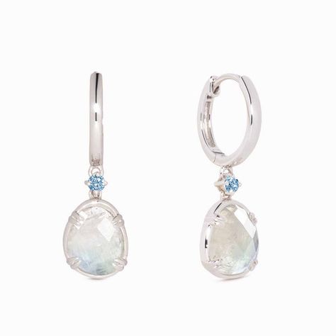 Our elegant silver drop earrings feature organically-shaped rainbow moonstones with brilliant blue cubic zirconia accents.
Thanks to their ethereal blue and white tones, these moonstone dangle earrings are truly one-of-a-kind!
The rainbow moonstones measure at 10mm x 8mm and cubic zirconia stone measure at 2.5mm.
Inner earring diameter measures at 10.5mm. Ethereal Blue, Gem Earrings, Moonstone Earrings, Blue Gems, Sustainable Jewelry, Traditional Jewelry, Silver Drop Earrings, Recycled Sterling Silver, Moon Stone