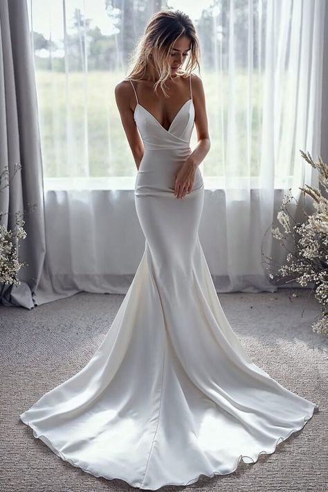 15 Minimalist Wedding Dress Ideas for Effortlessly Chic Brides Mermaid Wedding Dress Minimalist, Low Back Trumpet Wedding Dress, Sleek Low Back Wedding Dress, Classic Simple Wedding Dresses, Simple Satin Wedding Dress Classy, Silk Wedding Dress With Lace Sleeves, Plain White Mermaid Wedding Dress, Modern Fit And Flare Wedding Dress, Bridal Wedding Reception Dress