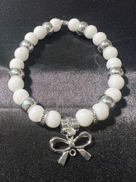 Beautiful white stone beaded bracelet with silver  and a charm. This bracelet can be worn for any occasion and and is nickel free. White Bead Bracelet, Marvel Jewelry, White Beads Bracelet, White Bracelet, White Bracelets, Gift List, White Stone, White Beads, Bead Bracelet