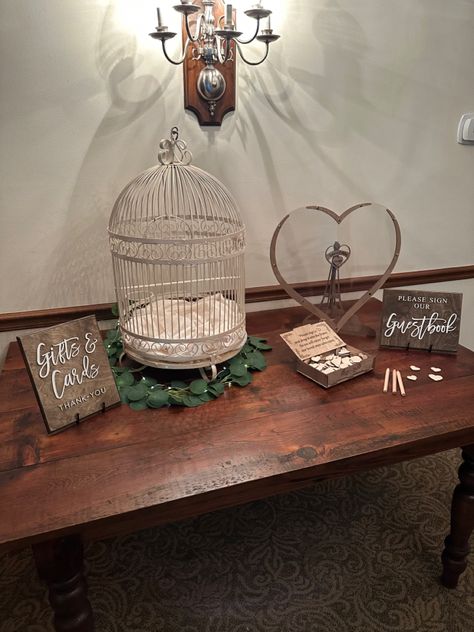 Our included bird cage and barn wood gift table. Paired with our wedding sign rentals. Bird Cage Card Holder Wedding, Bird Cage Wedding Decor, Wedding Birdcage, Sweetheart Table Wedding, January Wedding, Guest Book Table, Book Table, Wedding Card Holder, November Wedding